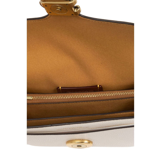 Interior view of Coach Tabby 20 leather crossbody bag showcasing fabric lining and multifunctional pockets with zip.