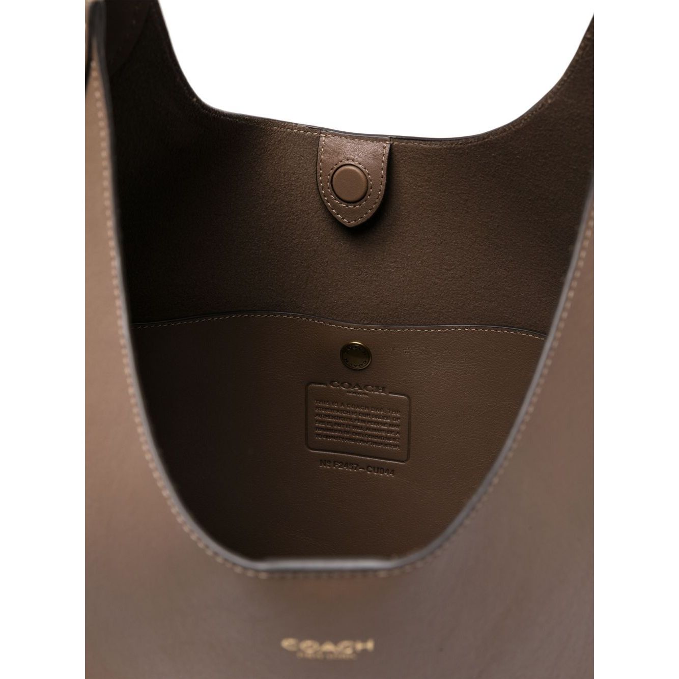 Interior view of Coach Brooklyn leather hobo bag in light brown calf leather with magnetic fastening and logo details.