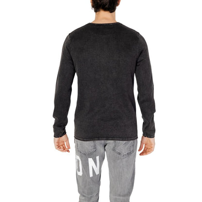 Back view of Jack Jones Black Cotton Sweatshirt on male model wearing gray jeans, showcasing long sleeves and crew neck design.
