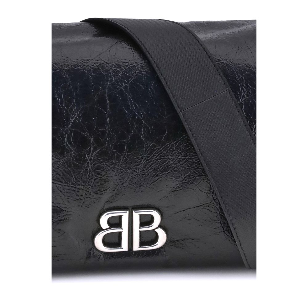 Close-up of Balenciaga Black Calf Leather Bos Taurus Shoulder Bag with silver-tone logo on grained-textured leather flap.