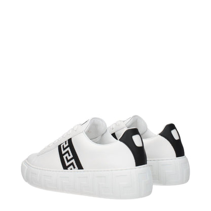 Versace White Leather Low Top Sneakers with black accents, featuring a front logo, lace-up closure, round toe, and rubber sole, side view.