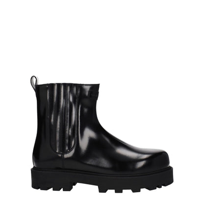 Givenchy Black Leather Ankle Boots with logo detailing, rubber sole, mid heel height, and round toe design in black leather.