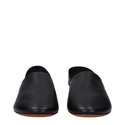 Front view of Givenchy Black Leather Mules, featuring a round toe design, side and back logos, with a low flat heel, crafted from leather.