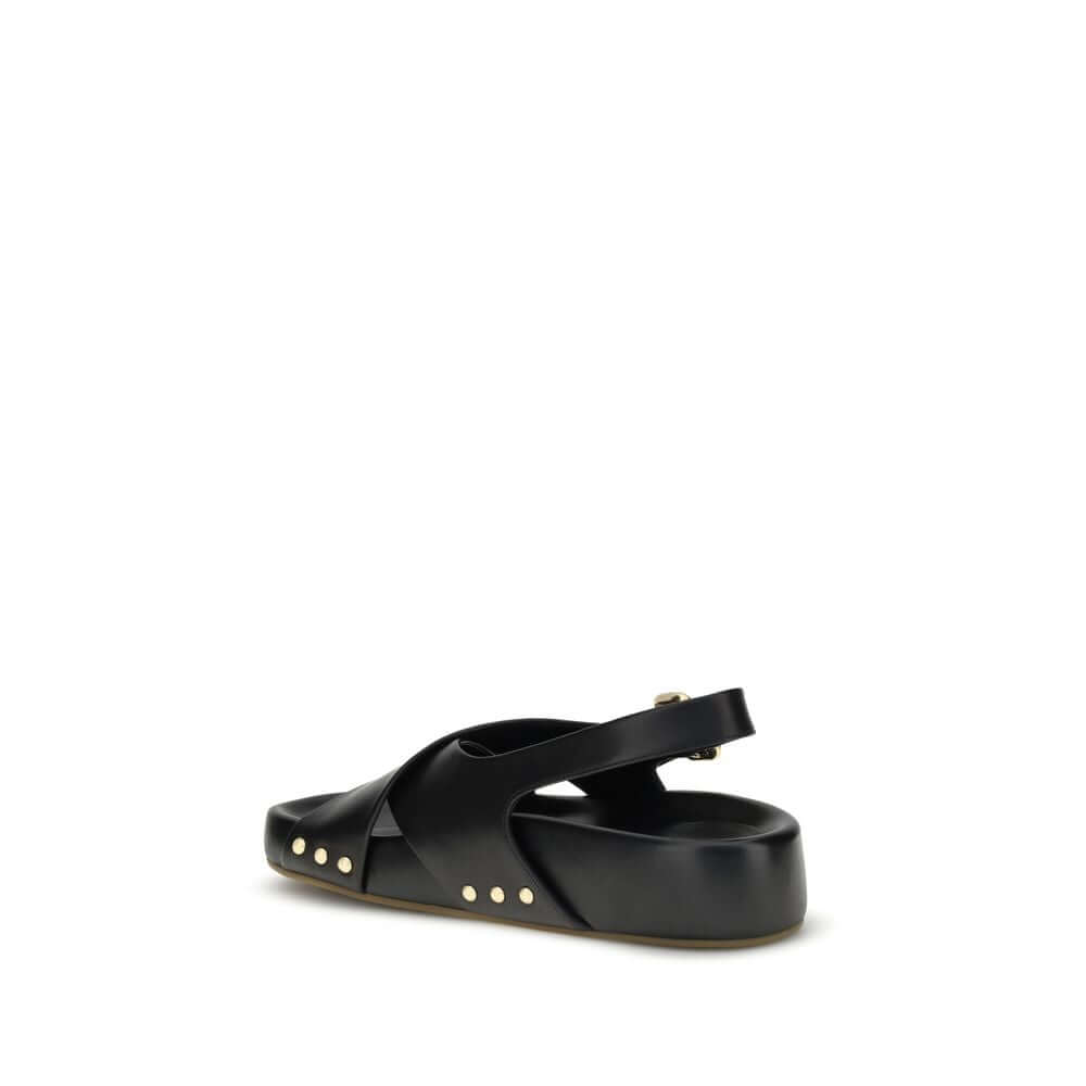 Back view of Chloé Mae Sandals in black calfskin with gold studs, featuring crossed straps and adjustable ankle strap for AW25 collection.