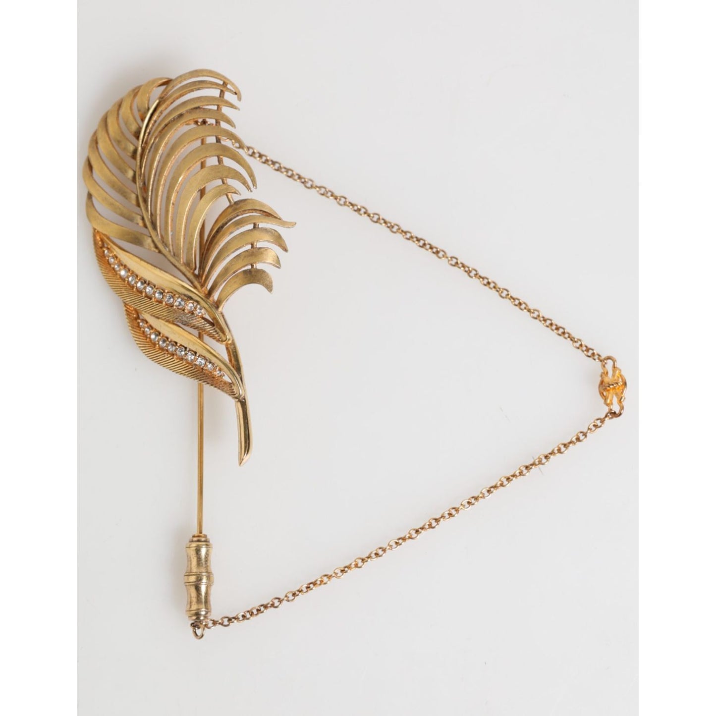 Dolce & Gabbana Gold Tone Leaf 925 Sterling Silver Crystal Chain Brooch with elegant leaf design and delicate chain.