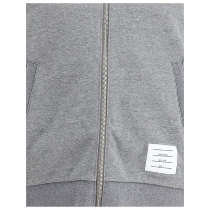 Thom Browne Gray Cotton Sweatshirt with front zipper, logo patch, and signature sleeve bands, showcasing stylish and comfortable design.