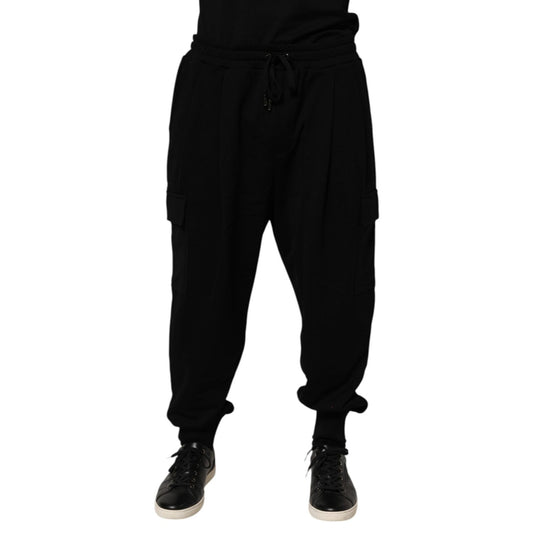 Men wearing Dolce & Gabbana Black Cotton Blend Cargo Joggers Drawstring Pants with elastic waistband and side pockets.