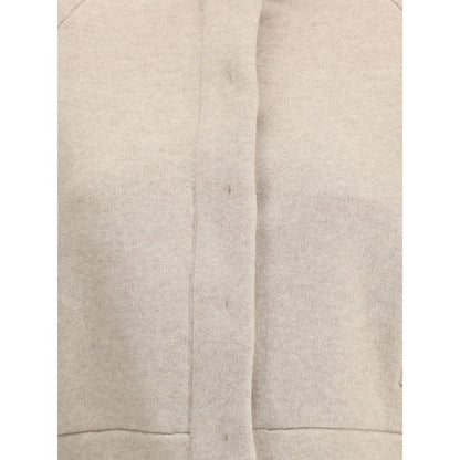 Brunello Cucinelli Beige Cashmere Clothing with button and zipper closure detail, showcasing luxurious texture and contemporary style.
