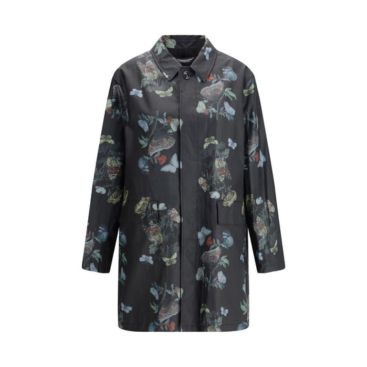 Undercover Black Cotton Coat with floral pattern, front view. Waxed cotton raincoat with flap pockets and cotton lining, AW25 collection.