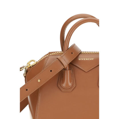 Close-up of Givenchy Brown Calf Leather Bos Taurus Handbag with strap, showing shiny leather and iconic monogram design.