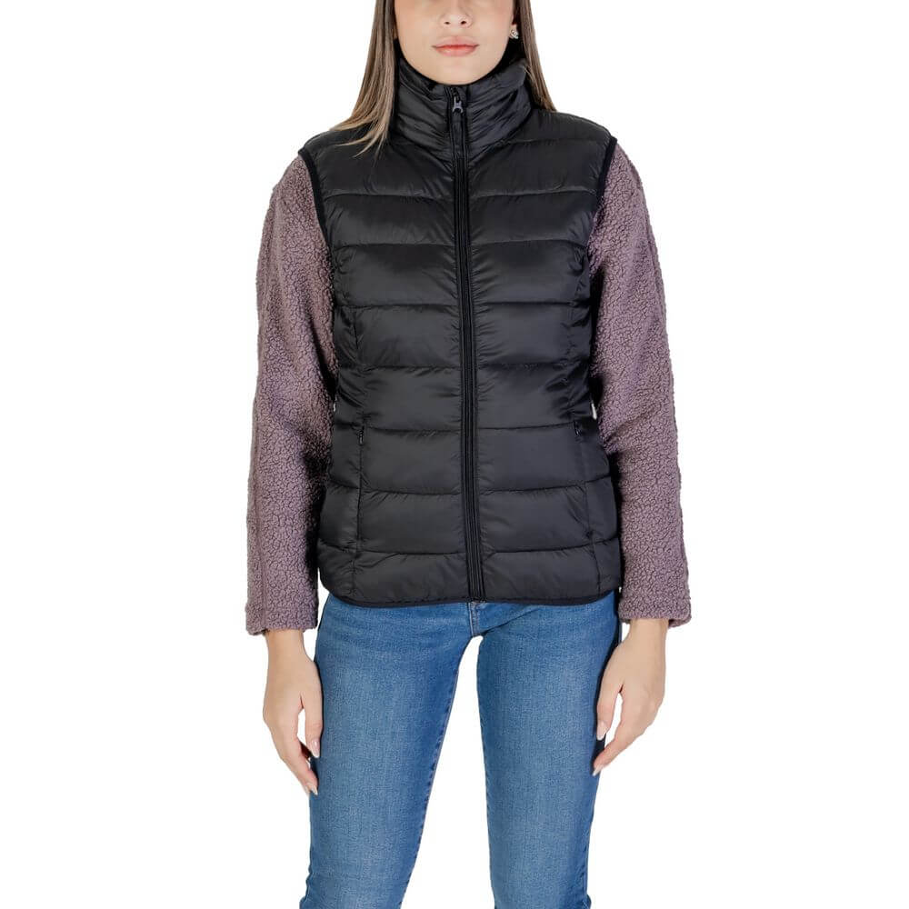 B.Young Black Nylon Sleeveless Jacket with quilted design worn by woman over a purple sweater and blue jeans.