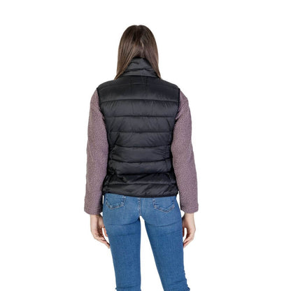 Back view of B.Young Black Nylon Sleveless Jacket worn by woman, emphasizing quilted design and durability for versatile style.