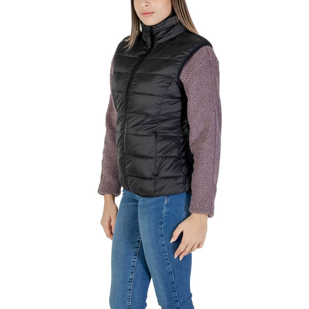 Woman wearing B.Young Black Nylon Sleveless Jacket with quilted design and front zip closure, ideal for transitional seasons.