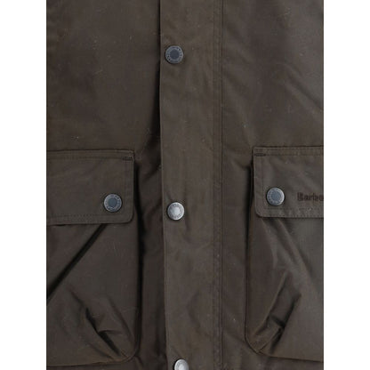 Close-up view of Barbour Brown Cotton Rain Coat with buttoned flap patch pockets and snap closures.