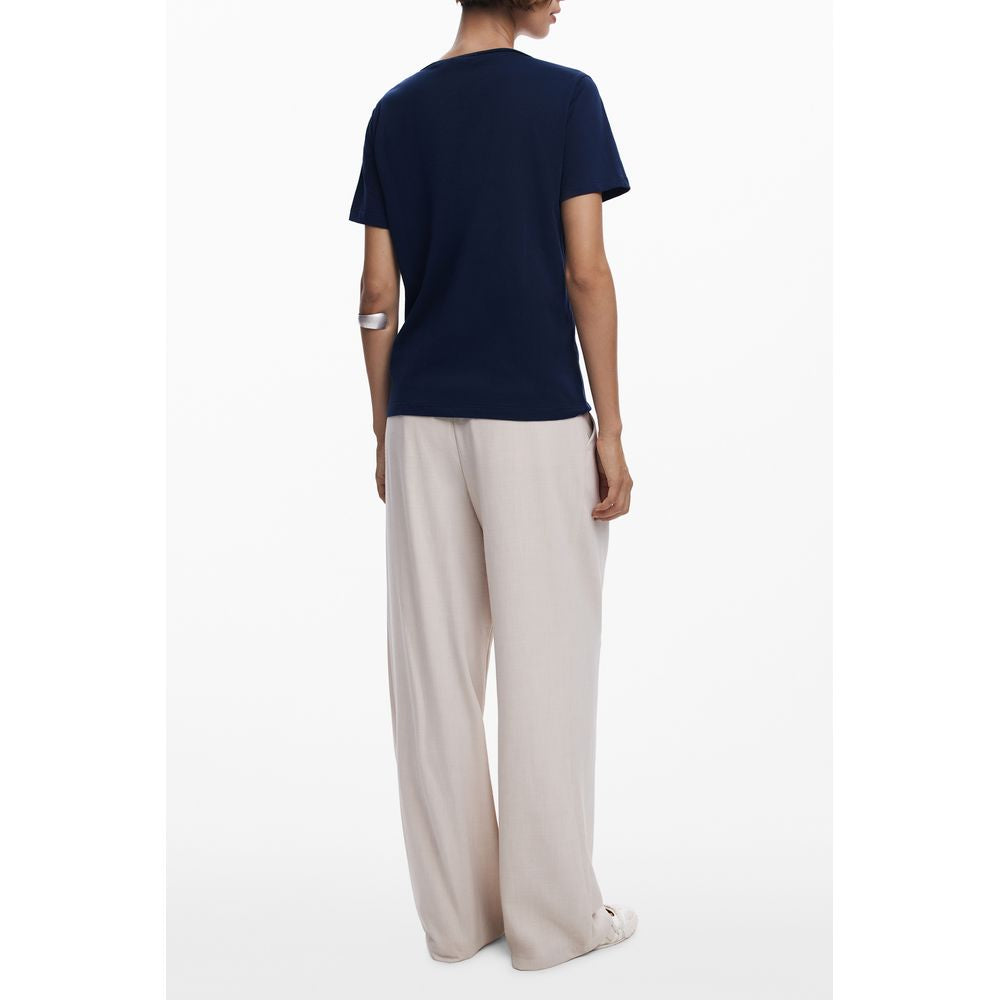 Back view of Desigual Blue Cotton Women T-Shirt worn with beige pants, showcasing its short sleeves and chic design.