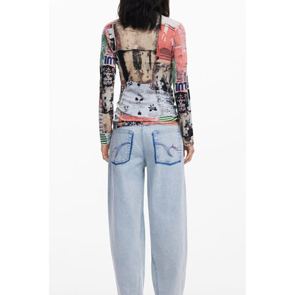 Woman wearing Desigual Pink Viscose Women Sweater with bold patterns and light blue jeans, showcasing unique back design.