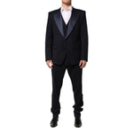 Man wearing Dolce & Gabbana Black 3 Piece Wool Silk Blend Suit SICILIA with satin peak lapels.