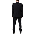 Back view of Dolce & Gabbana Black 3 Piece Wool Silk Blend Suit SICILIA, featuring elegant tailoring and satin peak lapels.