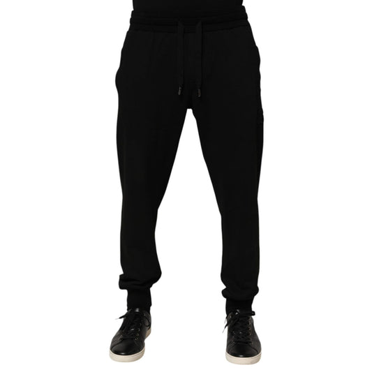 Dolce & Gabbana Black Cotton DG Logo Men Jogger Pants with drawstring closure and logo details, preowned with repaired holes near pocket.
