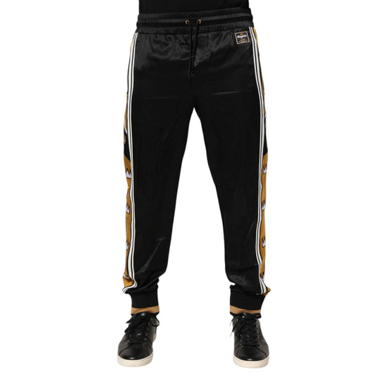 Dolce & Gabbana Black Gold Satin Crown Side Stripe Jogger Pants with ribbed cuffs and elastic waistband.