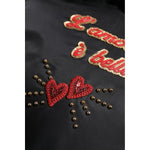 Dolce & Gabbana Black Heart L'Amore Patch Embellished Kids Backpack detail showing red heart embellishments and gold text.