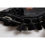 Close-up of Dolce & Gabbana Black Heart L'Amore Patch Embellished Kids Backpack with tassel details.