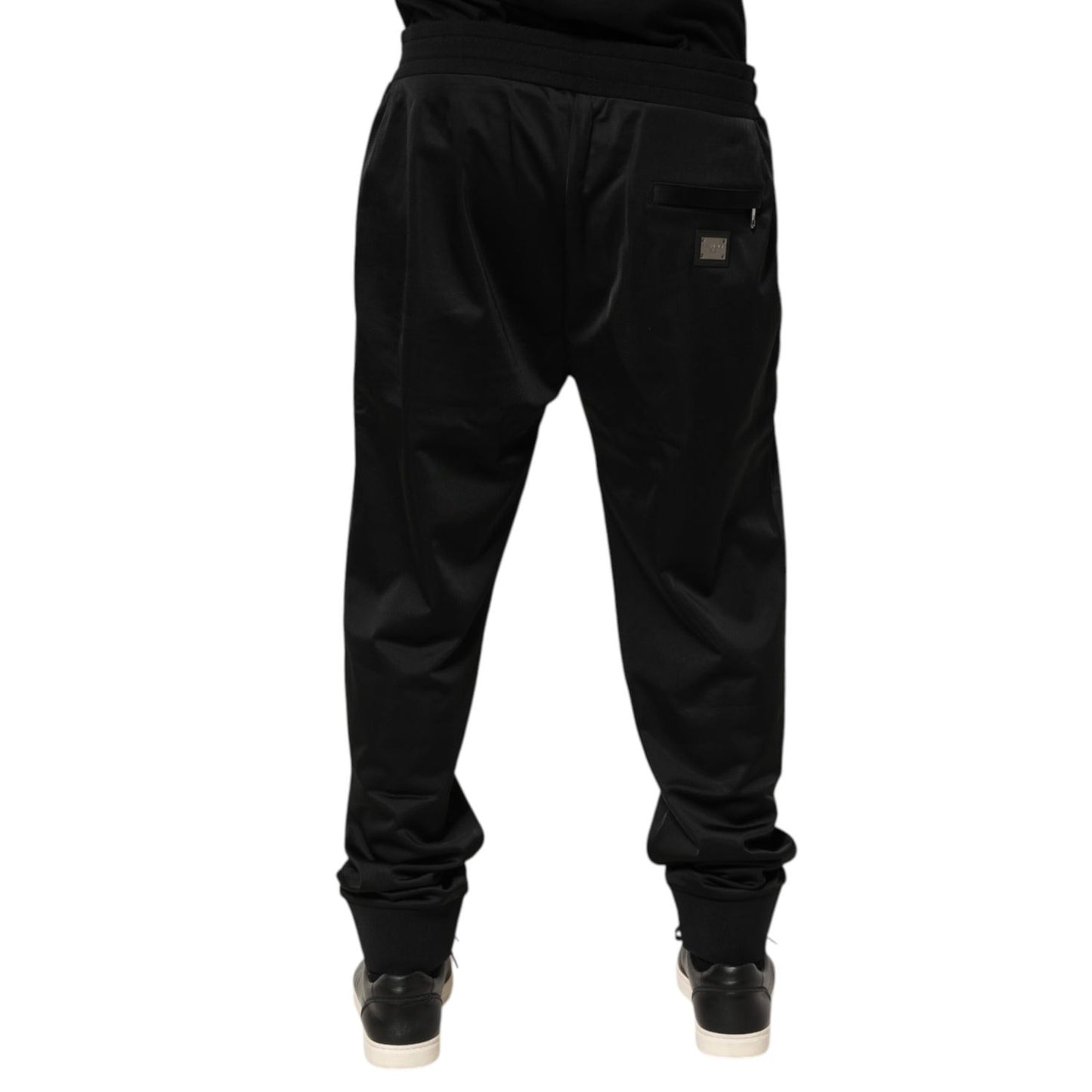 Rear view of Dolce & Gabbana Black Polyester Logo Plaque Sweatpants Jogger Pants showing the iconic logo plaque on the back pocket.