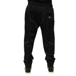 Rear view of Dolce & Gabbana Black Polyester Logo Plaque Sweatpants Jogger Pants showing the iconic logo plaque on the back pocket.