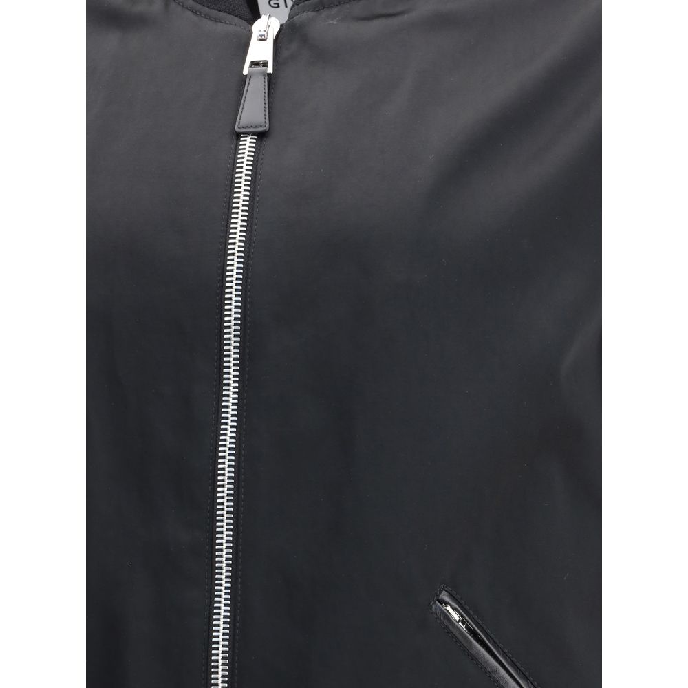 Close-up of Givenchy Black Cotton Bomber showing satin body and zipper details.