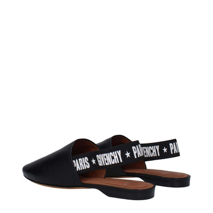 Givenchy Black Leather Slides with side and back logo, casual style with round toe, low flat heel, and white accents.