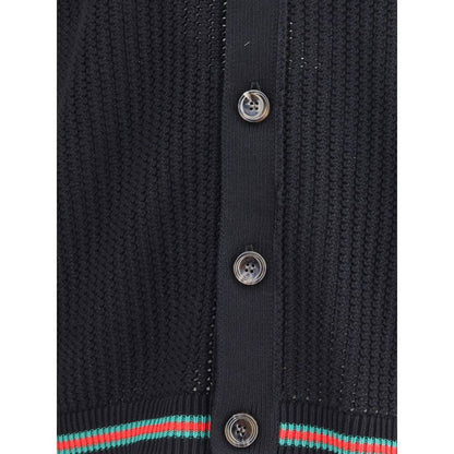 Close-up of Gucci Black Cotton Cardigan with button details, showcasing knit texture and ribbed hem for a refined look.