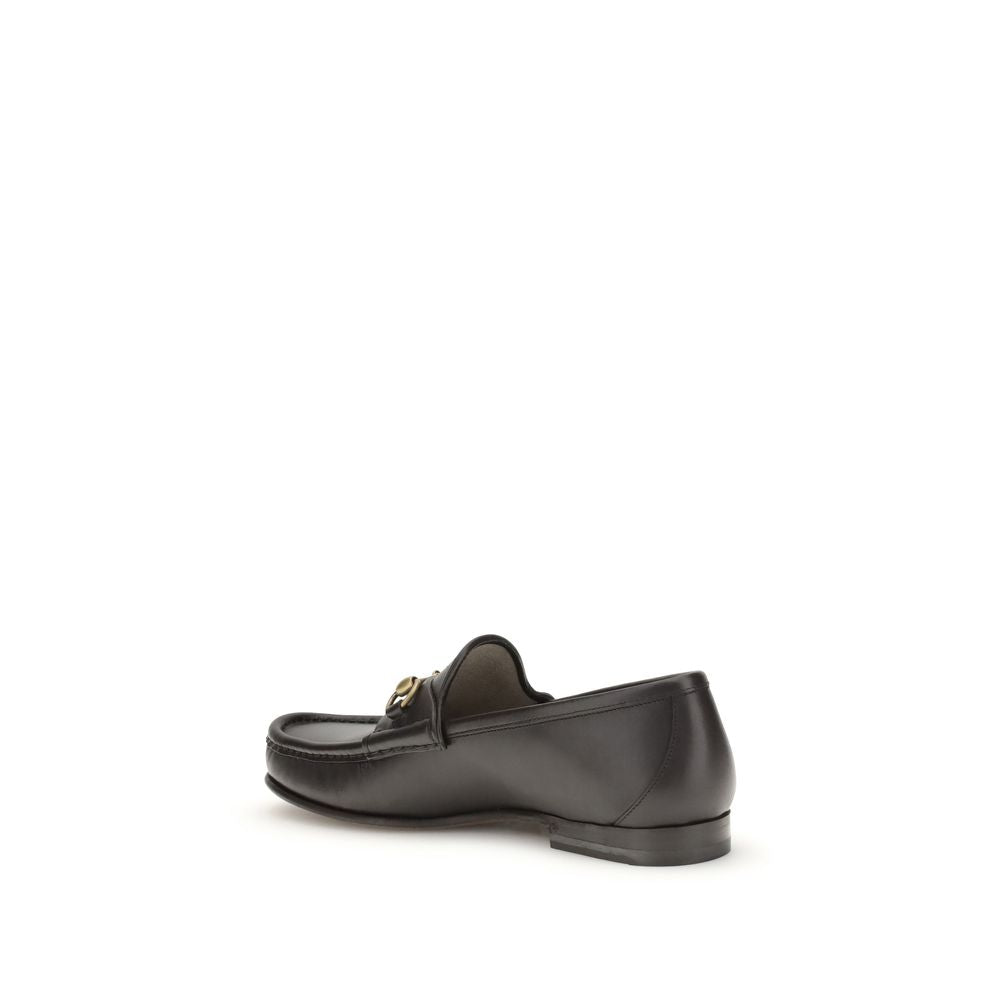 Gucci Brown Calf Leather Bos Taurus Slip-On Loafers with Horsebit detail in dark brown leather, side view.