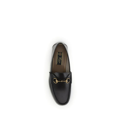 Gucci Brown Calf Leather Bos Taurus Slip-On Loafers with Horsebit detail and gold-tone hardware, top view of luxury footwear.