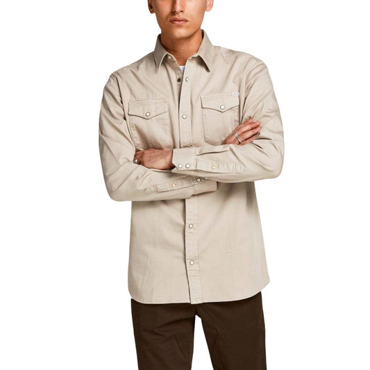 Model wearing Jack Jones Beige Jeans Shirt with long sleeves and chest pockets, showcasing cotton and elastane blend, perfect for any occasion.