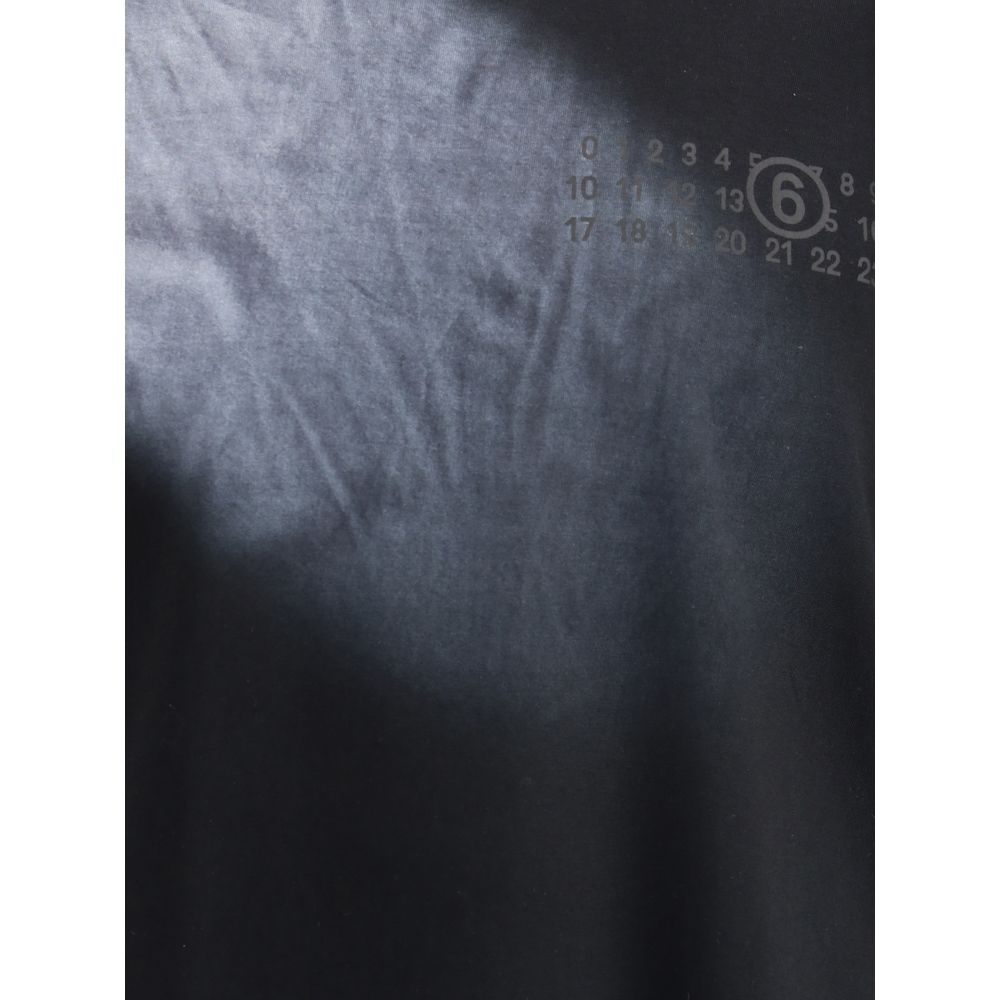 Close-up of MM6 Black Cotton T-Shirt showing logo detail, ribbed crew neck, and clean silhouette representing brand's minimal style.