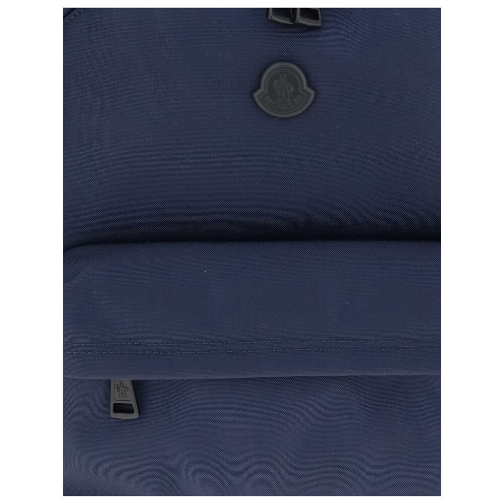 Moncler Blue Nylon Backpack with leather trim, metal logo, water-repellent fabric, adjustable straps, and zippered pockets for convenience.
