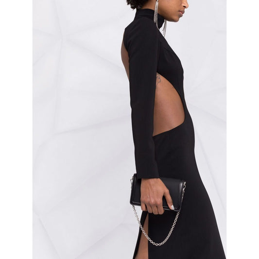 Model wearing Monot PRE high neck evening dress with side cut-out detail and black clutch