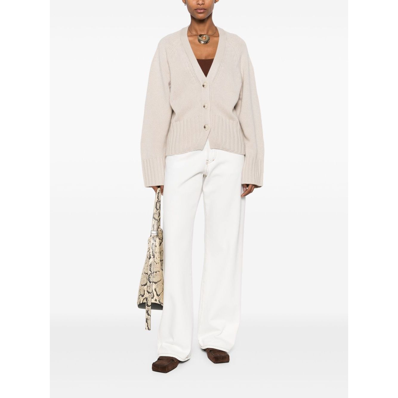 Model wearing SOFT GOAT Sweaters Ivory cashmere cardigan with ribbed trim and v-neck.