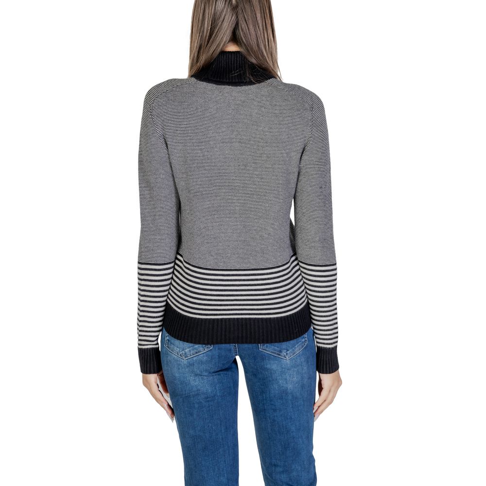 Back view of Sandro Ferrone Black And White Viscose Turtleneck with striped pattern on lower body and sleeves.