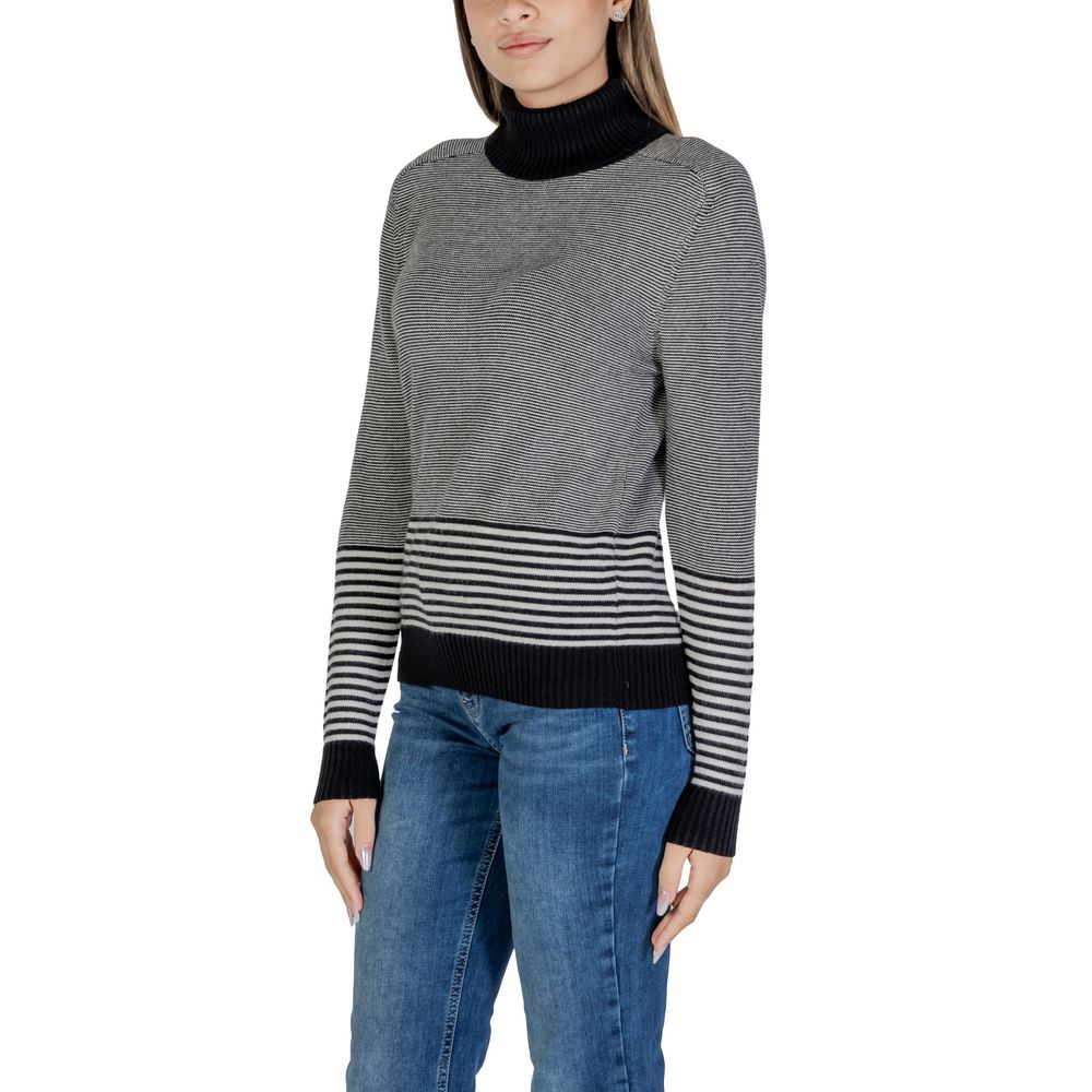 Sandro Ferrone Black And White Viscose Turtleneck sweater with striped pattern, worn by a model, showcasing elegant and modern design.