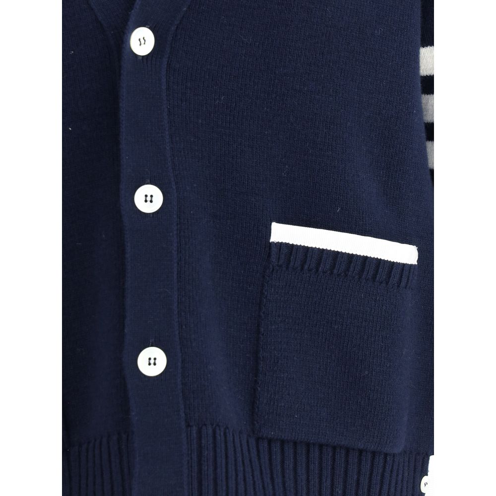 Close-up of Thom Browne Blue Merino Wool Cardigan showing buttons and patch pocket with contrasting piping.