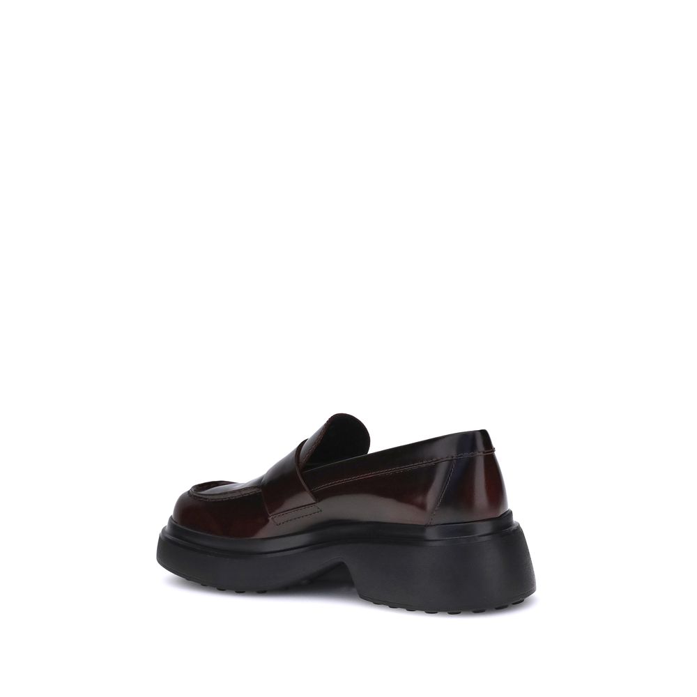 Rear view of Tod's Brown Rubber Platform Loafers with patent leather and distinctive side logo. Made in Italy with comfort-enhancing rubber sole.