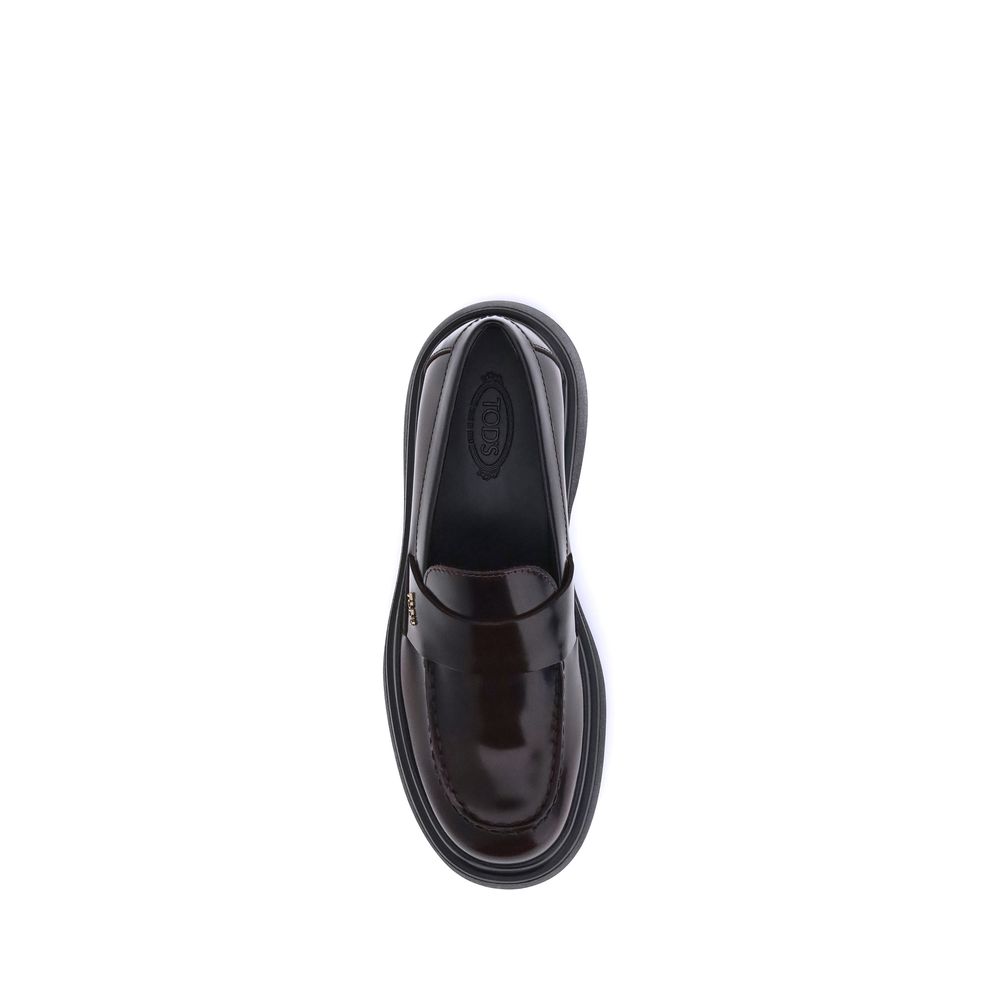 Top view of Tod's Brown Rubber Platform Loafers with patent leather finish, featuring a rubber sole and side logo plaque, made in Italy.