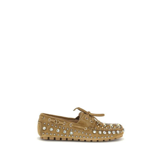 Valentino Garavani Beige Calf Leather Bos Taurus Slip-On Loafers with studs and rhinestones, featuring a durable leather sole.