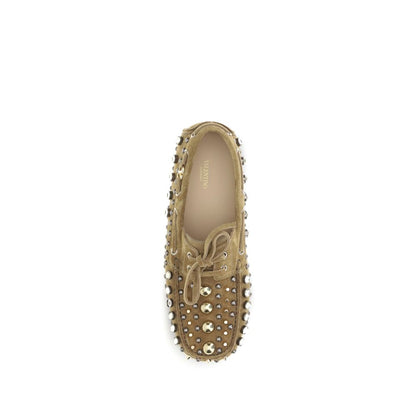 Valentino Garavani Beige Calf Leather Bos Taurus Slip-On Loafers with studs and rhinestones, top view.