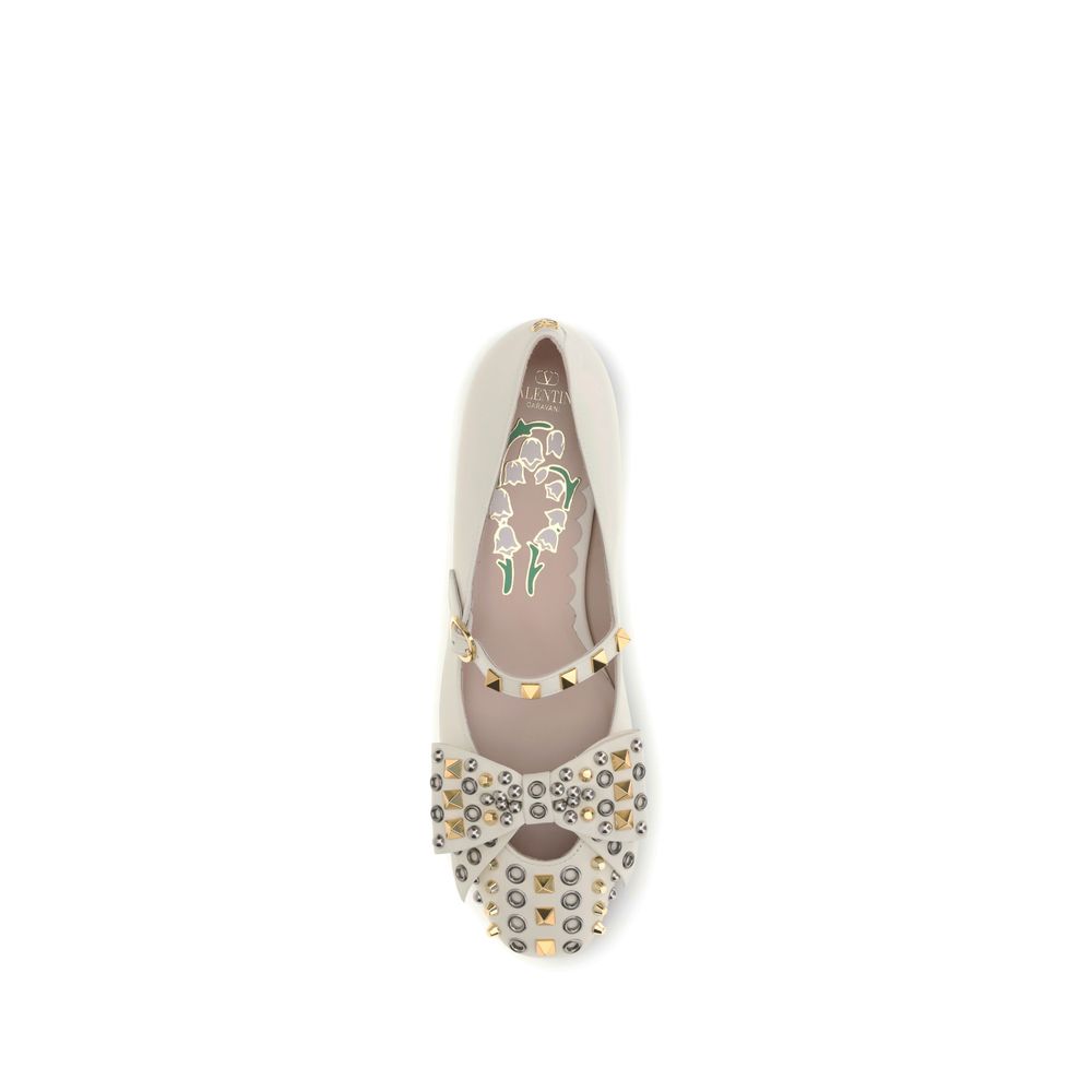 Valentino Garavani Cream Goatskin Ballet Flats with bow and floral footbed design, studded details, and brass VLogo.